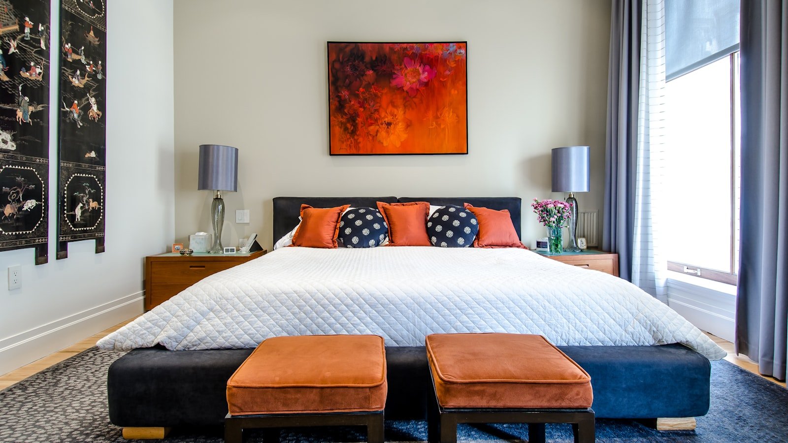 Modern bedroom with neatly made queen bed